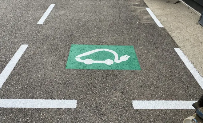 Stationnement véhicule hybride ou électrique avec borne de recharge.